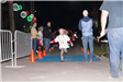 Young Girl Running Across a Finish Line