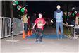 Young Boy Standing Across the Finish Line