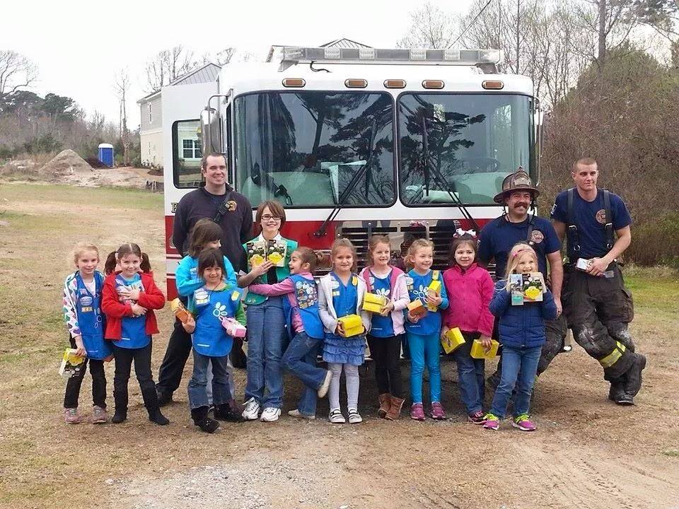 Group of Girl Scouts Standing with Firefighters in Front of a Fire Truck