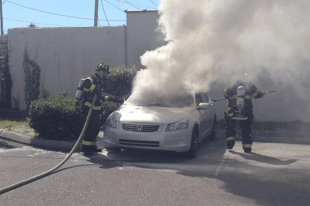 Firefighters Putting out a Fire in a Car