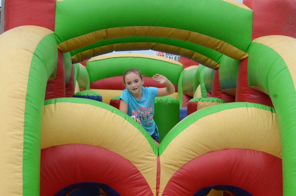 Young Girl Playing on a Bounce House