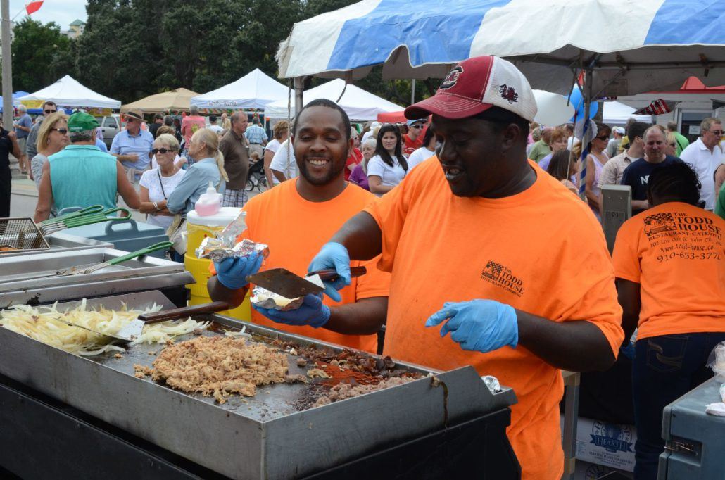 Two Men Cooking and Preparing Food on a Grill
