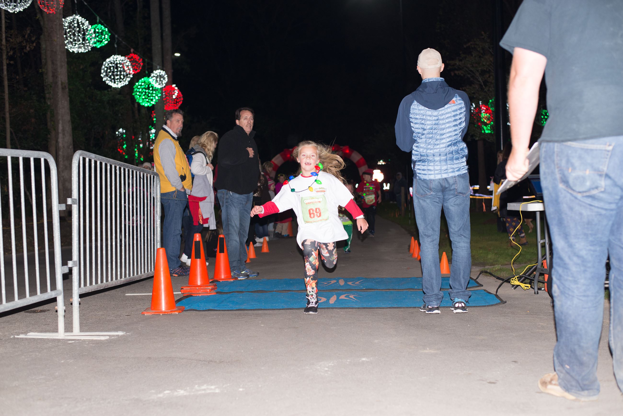 Young Girl Running Across a Finish Line