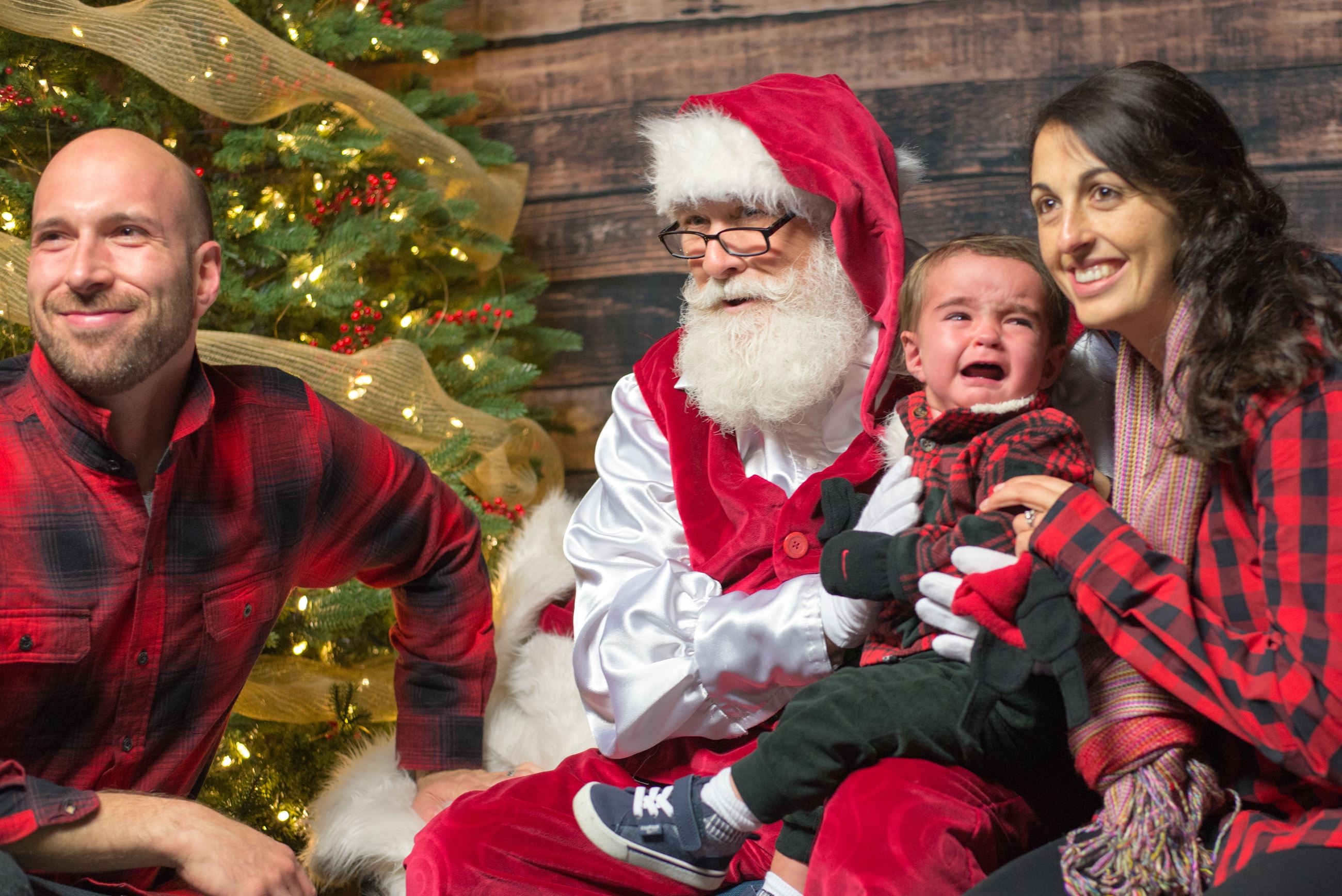 A Family Posing with Santa Claus