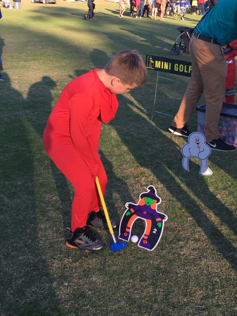 Child playing mini-golf